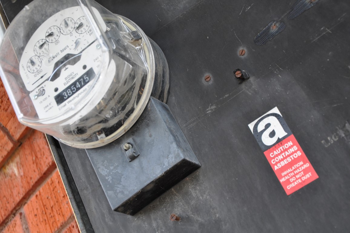 Bituminous electrical backing board and asbestos Asbestos